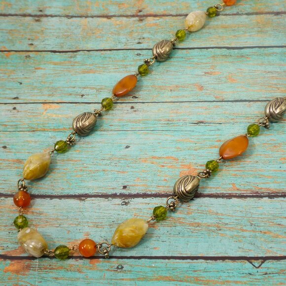 Multi color bead necklace with a mix of beige, green, and deep orange tones. - Picture 5 of 11